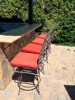 Four Outdoor swiveling bar chairs
