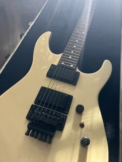 A 1987 Charvel Model 5 in Aged Pearl White.