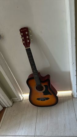 acoustic guitar with a broken string that you can replace