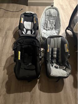 4 car seats and a baby rocker