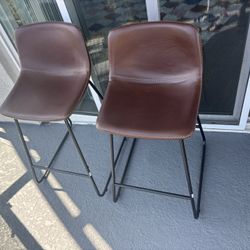 Two brown leather bar stools, like new condition. Selling them together only. 