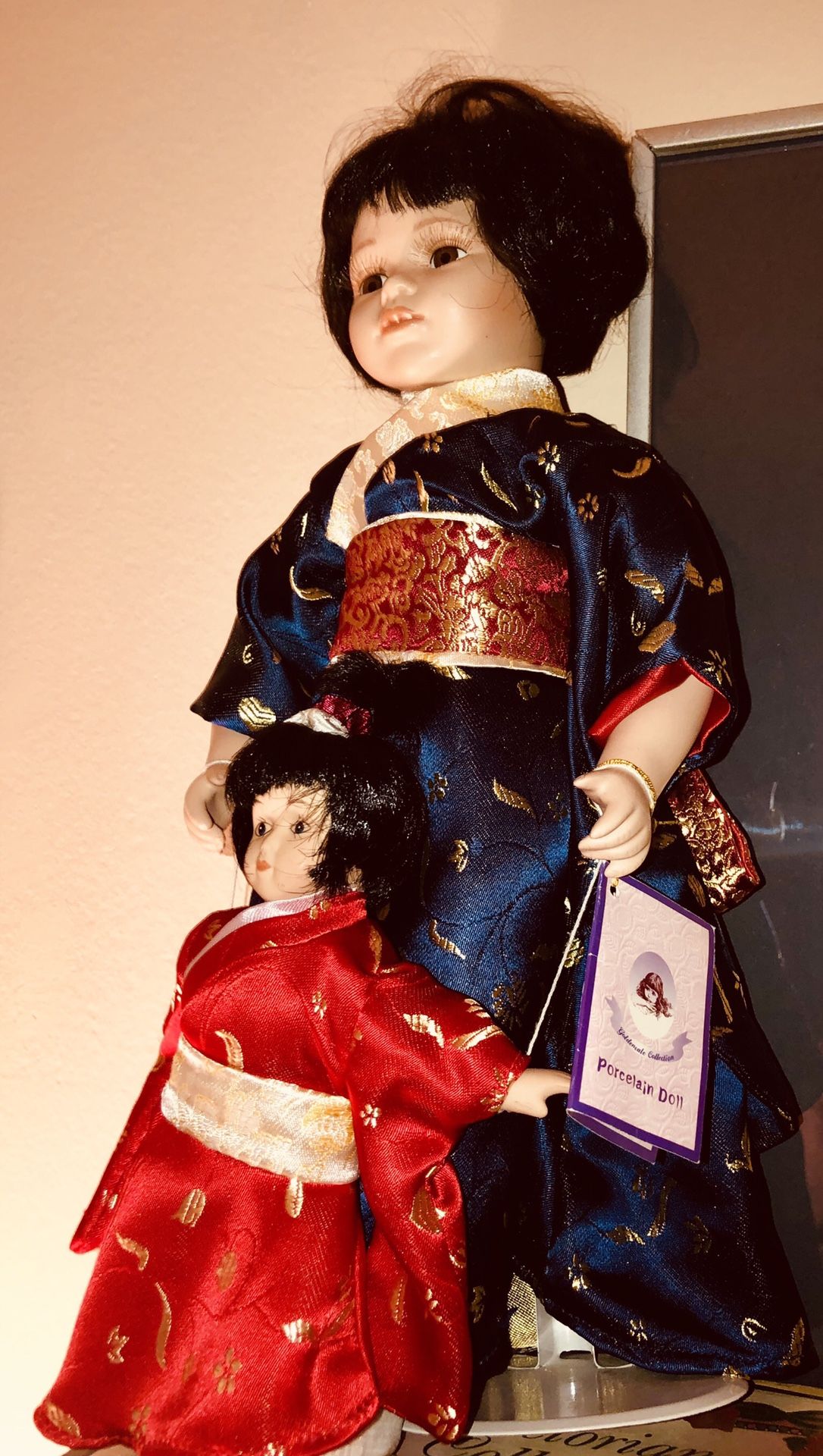 Set of 2 Large Chinese porcelain dolls. New with tags. Both wearing kimonas. The larger doll is wearing a blue kimona. The smaller doll is wearing a