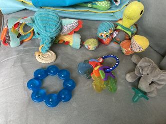 Assorted baby toys and tethers