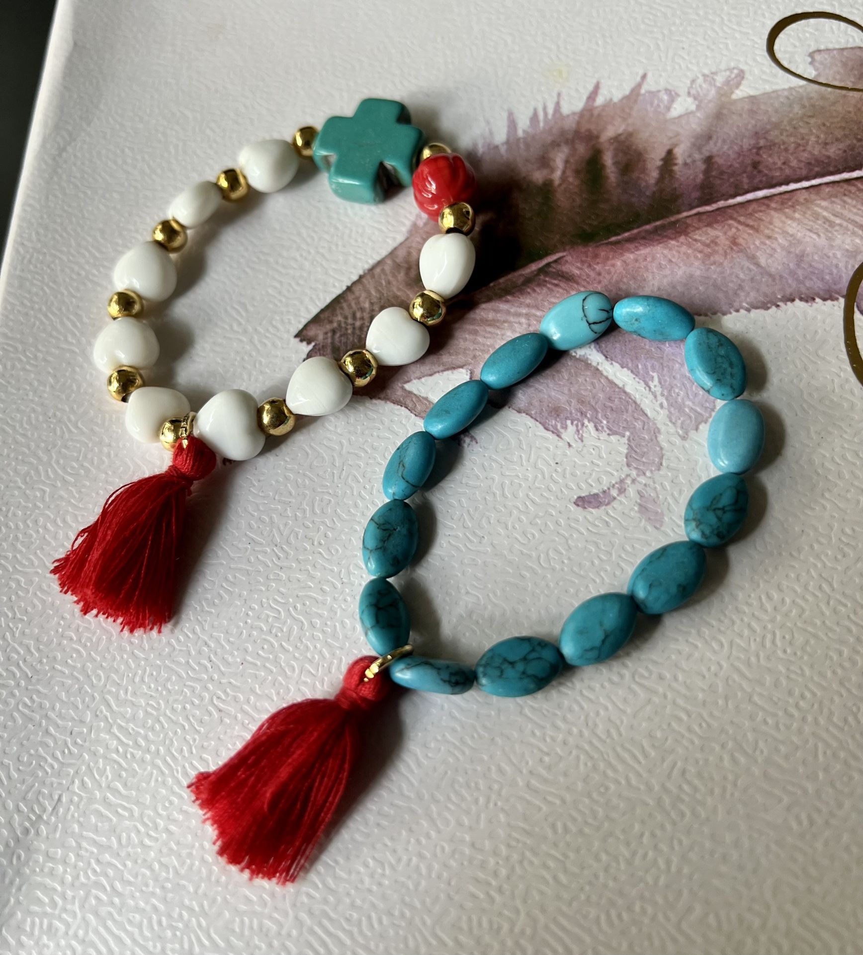 Turquoise And White Stone Bracelets With A Red Tassels