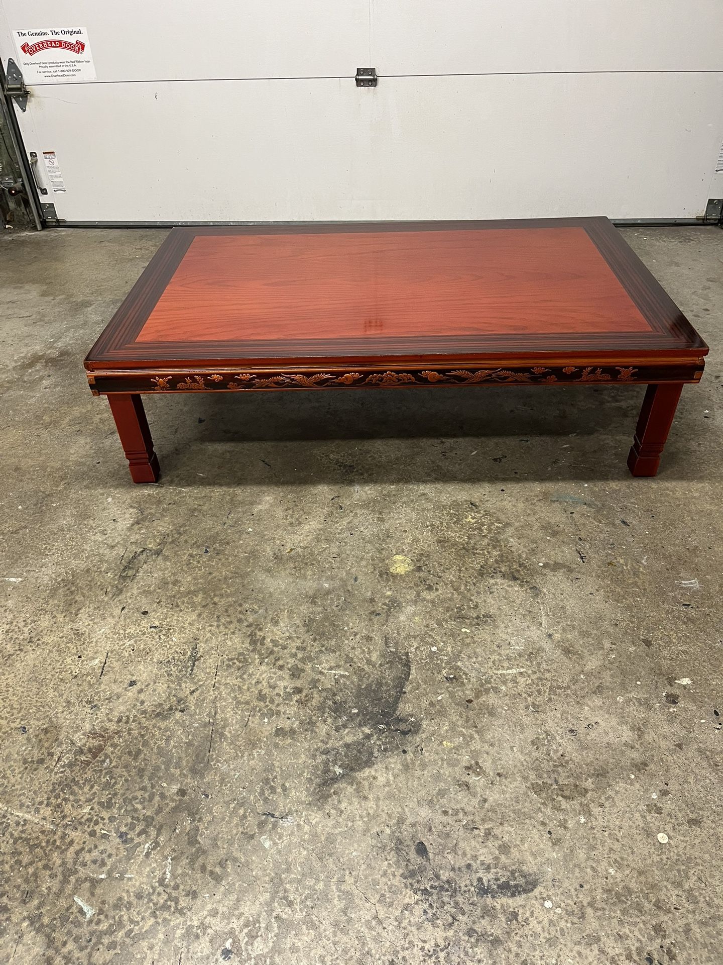 Beautiful Korean-style low-profile coffee or tea table, possibly made of rosewood or teak, with carved details and folding legs.