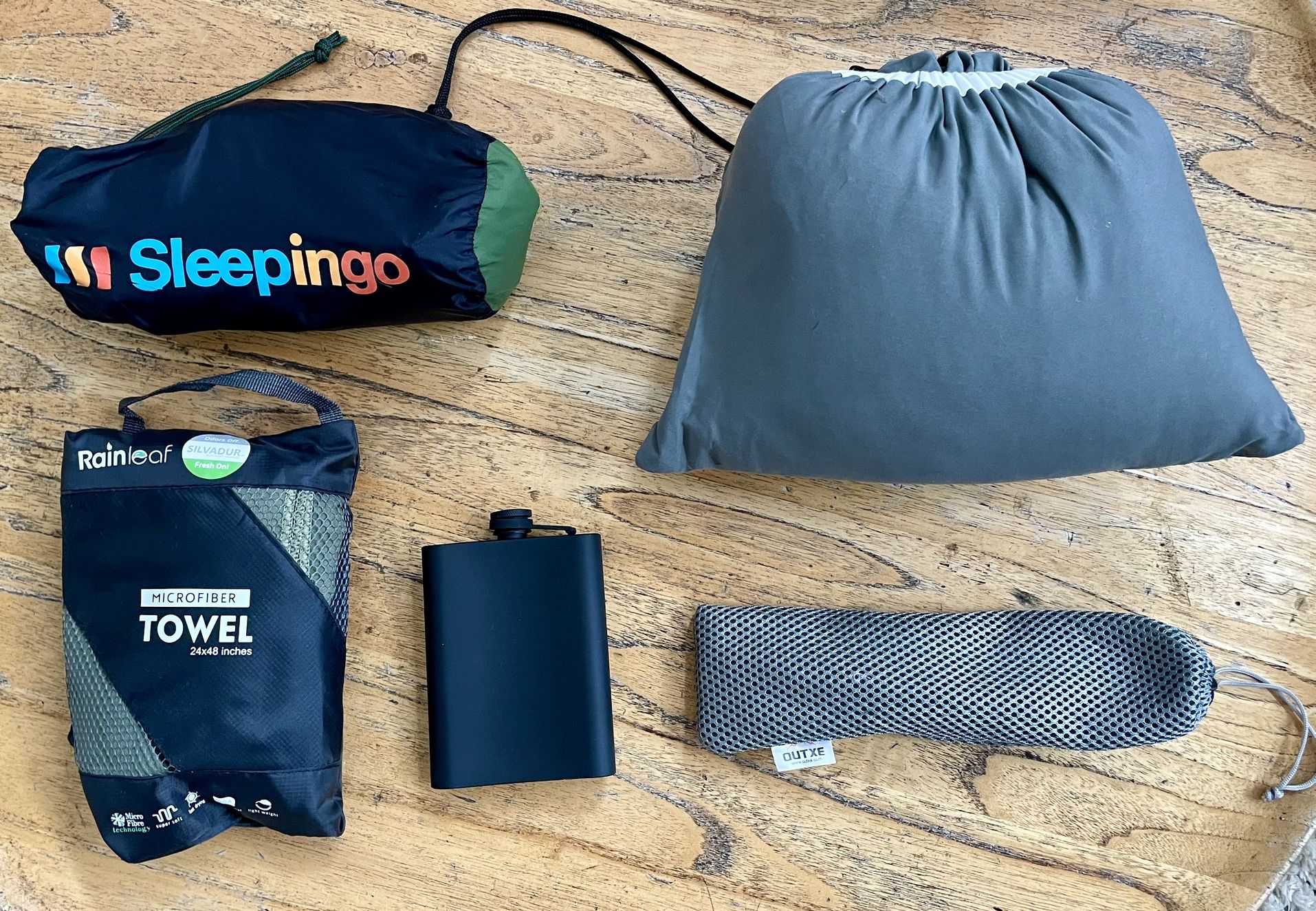 Camping supplies: air mattress, flask, utensil, towel, pillow