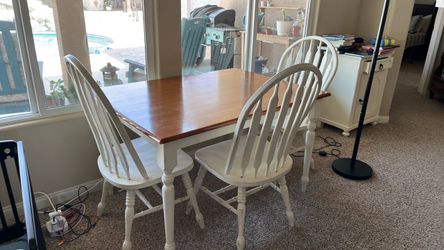 Dining table with three matching chairs and one odd chair