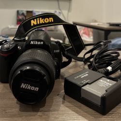 Nikon D3000 DSLR with Charger, Case, and Zomei Tripod (Camera Fully Functional)