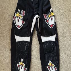Black motocross pants with Rocket Power / Rockstar Energy style graphics