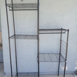 freestanding black metal wire closet organizer featuring modular stepped shelving and integrated hanging rods