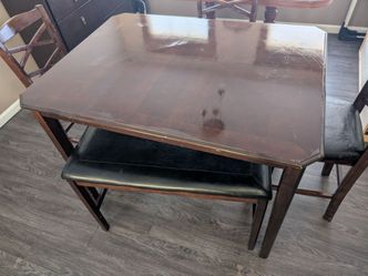 Dining room table with 3 chairs and one bench.