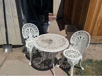 Cast-iron table with two chairs