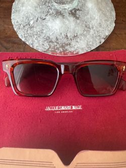 Jacques Marie Mage Belvedere sunglasses in a rich red and amber acetate frame with signature gold-tone arrowhead front pins.