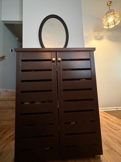 Dark Brown Wood Shoe Cabinet with Dark mirror.