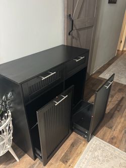 Black slide out trash can/laundry cabinet