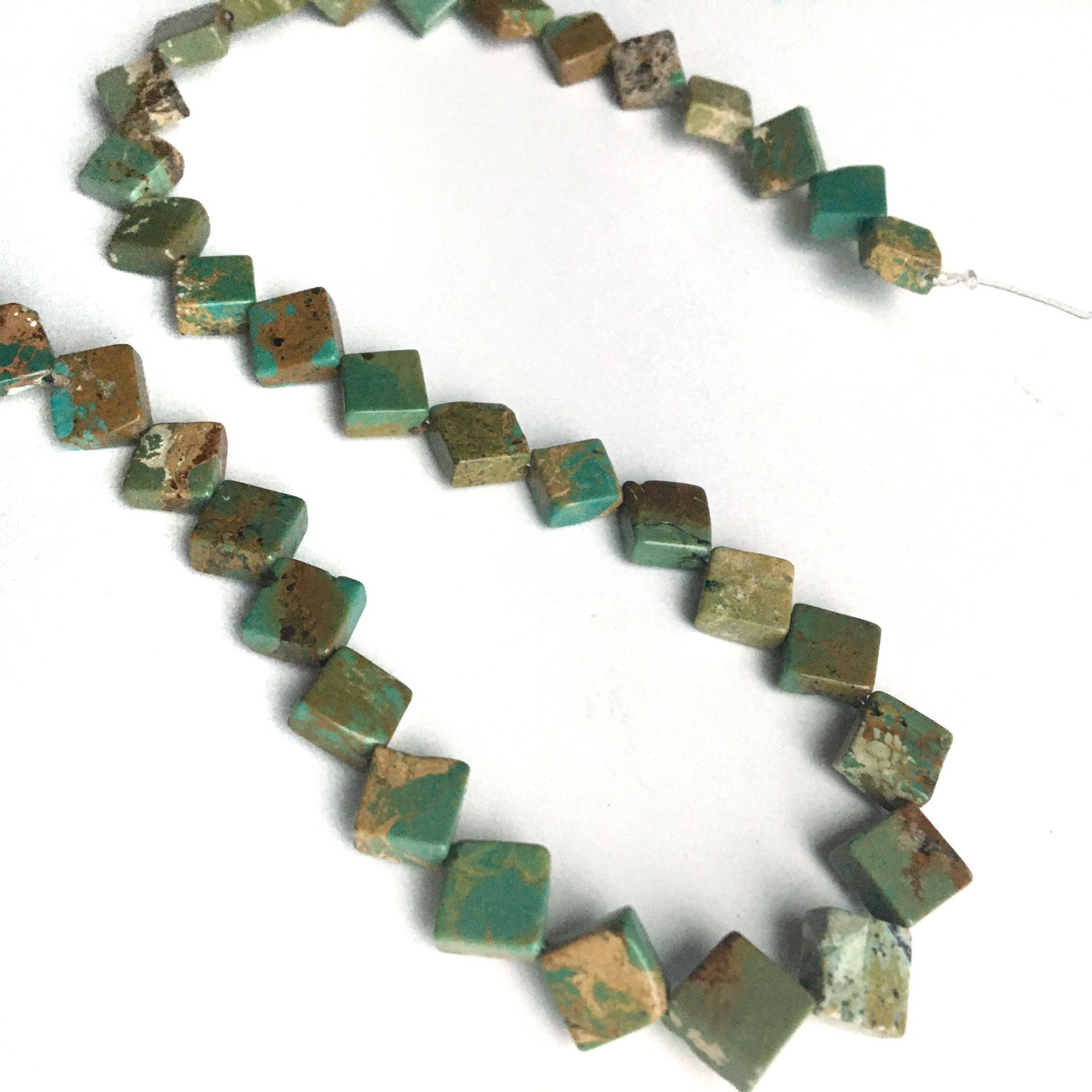 Turquoise flat cube beads drilled on point