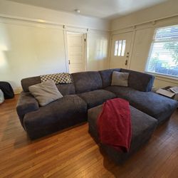 Very comfortable grey couch with ottoman