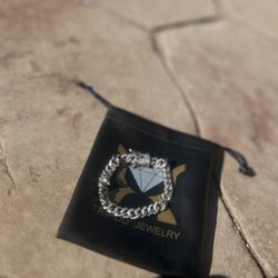 This is a Tripod Jewelry iced-out Cuban link bracelet, likely in white gold or silver with VVS moissanite or lab-made stones. 