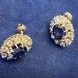 Sapphire stud a little over half an inch but 2 1/2 carrots in the center oval. Vvs1 Round total vvs 1 c. Real diamond.