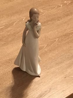 Lladro Porcelain Figurine of sweet girl and a flower.