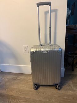 “20-inch suitcase with a ribbed aluminum design.”