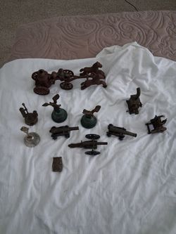 Vintage cast iron toys and bells and a  brass owl paperweight