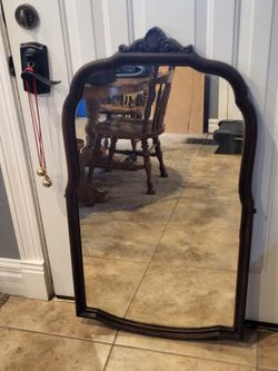 Ornate dark wood wall mirror approx 21x38"