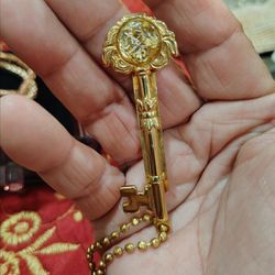 Gold Oriental vintage key ,used for prosperity , costume jewelry
