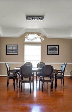 Modern baroque black lacquer dining-room table with crocodile pattern chairs