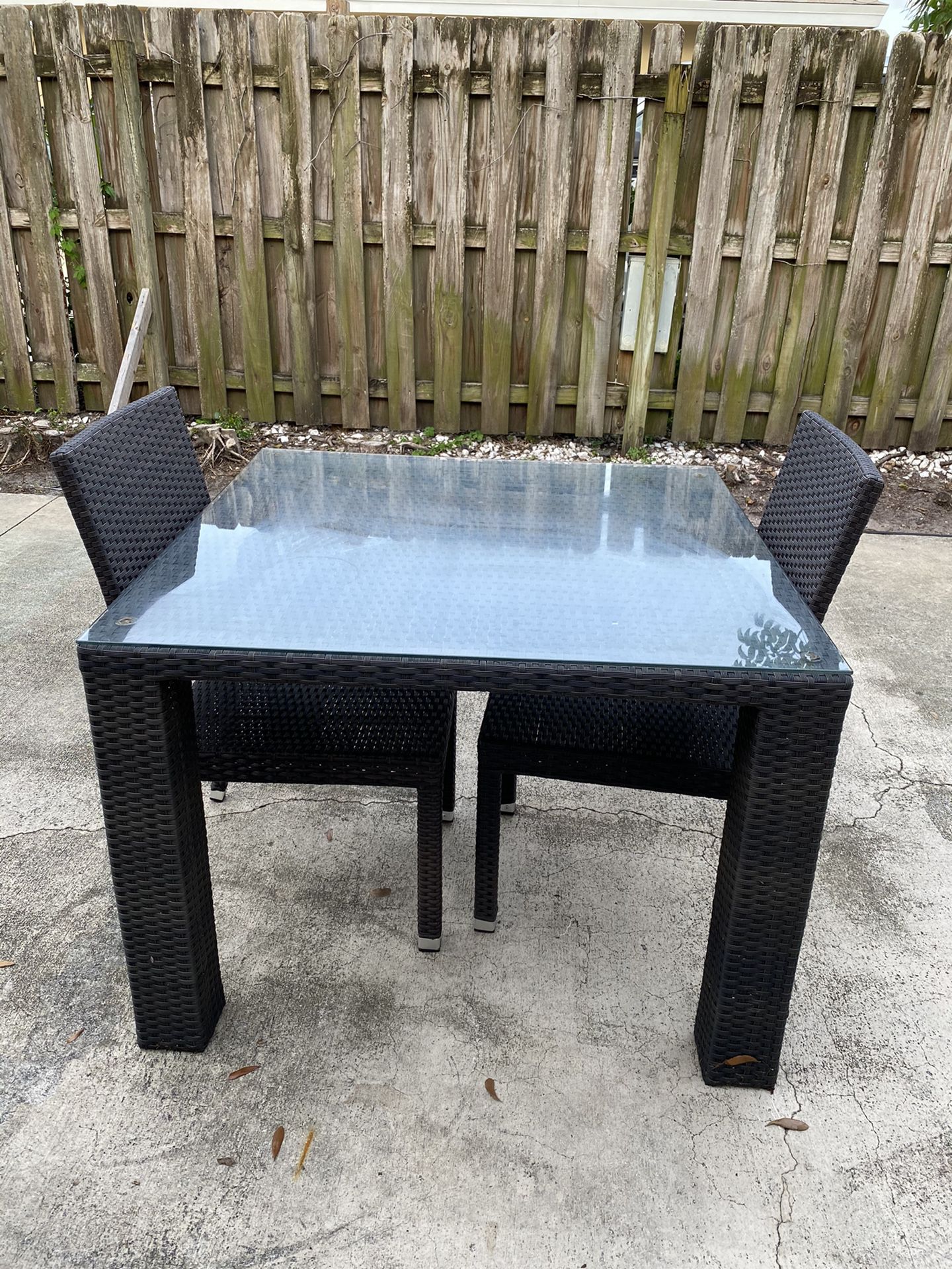 Outdoor table with two chairs from City Furniture. (Glass top)