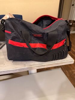black and red Craftsman canvas/polyester tool bag with dual carrying handles and a wide-mouth zipper