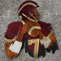 The piece is known as the "Redskins Joe Theismann #7 Metal Wall Art" produced by Elements.
