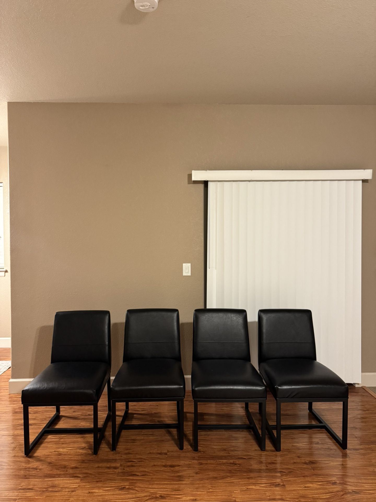 4 black leather chairs