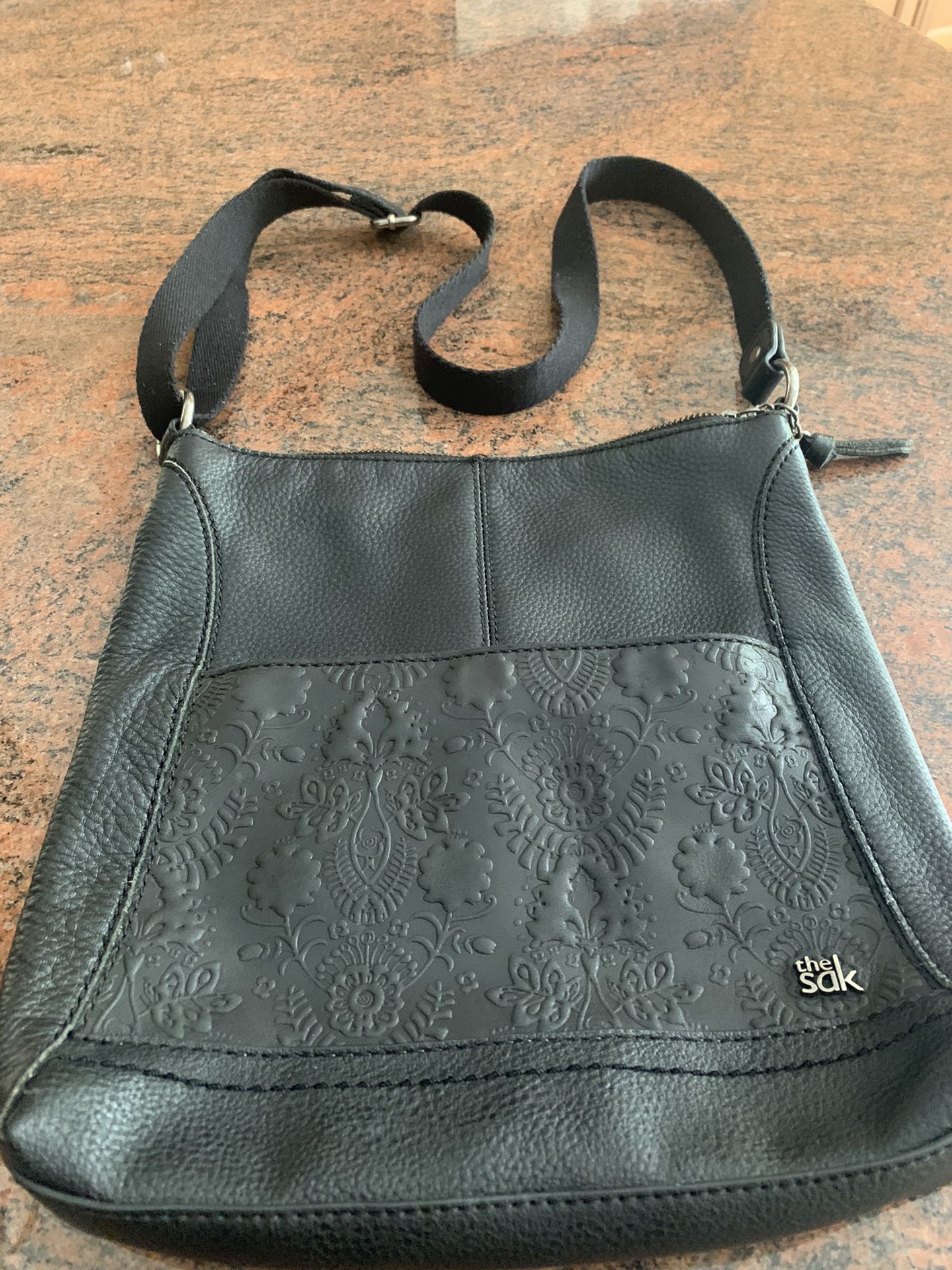 The SAK Black Leather Crossbody Hobo  Bag   12”x11”     Inside And Outside Pockets  Bag Is Very Good Condition  with wear stains  Inside by zipper   