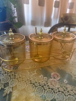 3 golden containers for kitchen with spoons
