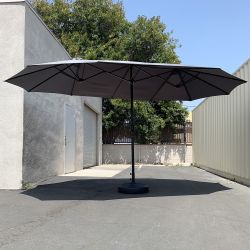 $130 (New) Large 15ft double sided outdoor umbrella w/ 65 lbs plastic weight base (red/gray) 