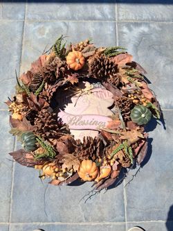 24" Autumn wreath with faux pumpkins, pinecones, fall leaves, and berry clusters. Great for front door or wall display...asking $25.00
