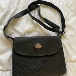Gucci Vintage Mini Gg 80s Black Coated Canvas Cross Body Bag  8.5"L x 2.5"W x 7"H  DESCRIPTION Perfect little vintage Gucci Crossbody with knotted str