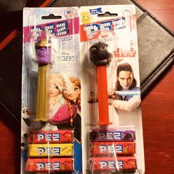 (2) Factory Error Pez Dispensers (Marvel Figure in a Disney Frozen Package, ( How To Train Your Dragon Star Wars Package