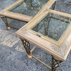 Set of two glass top coffee tables with decorative metal legs.$55 for both.