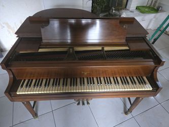 vintage brown wooden baby grand piano featuring the "Kramer New York"