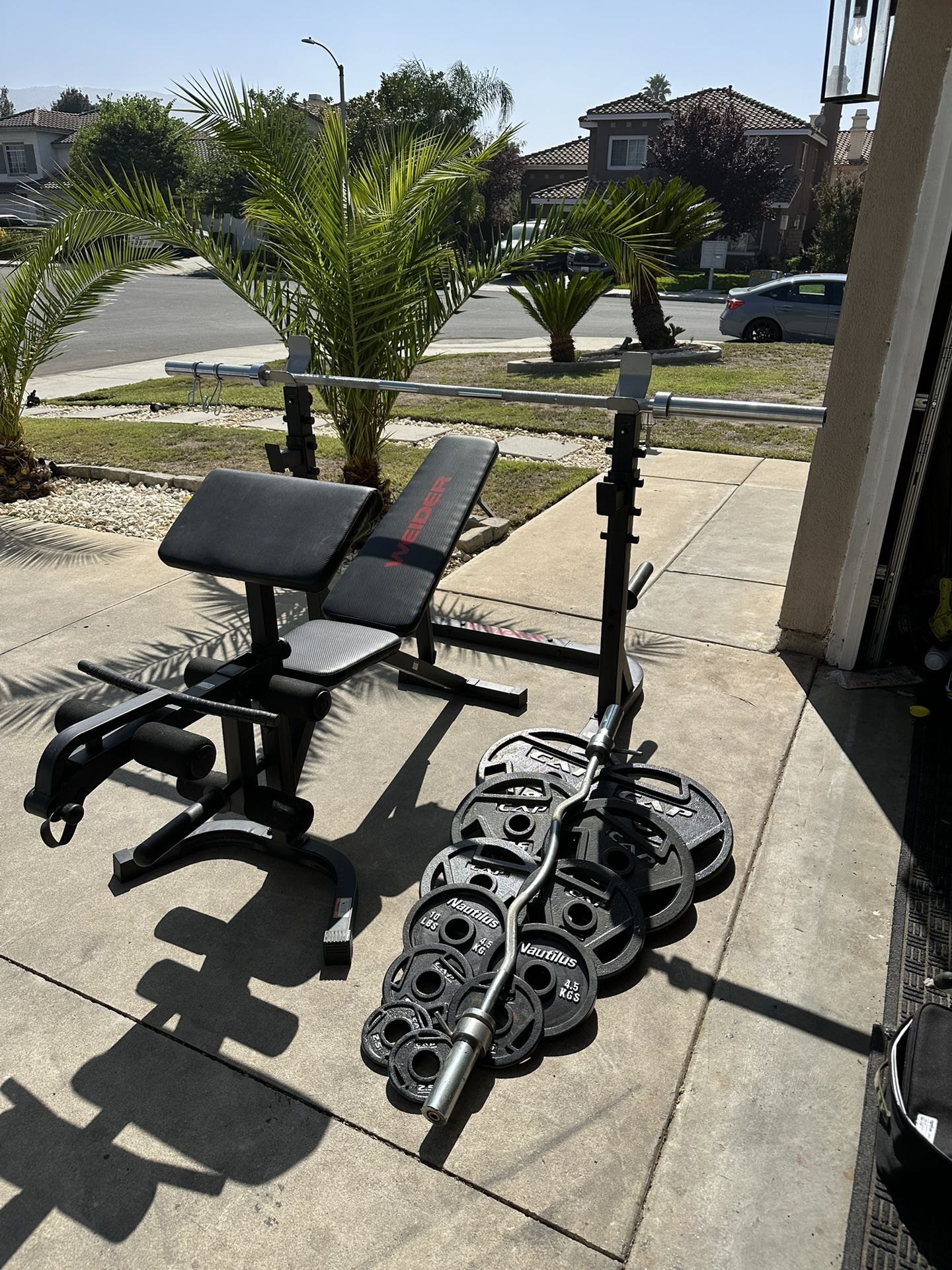 Bench press/squat rack with 7ft 45lbs bar plus 245lbs of Olympic weights and curl bar