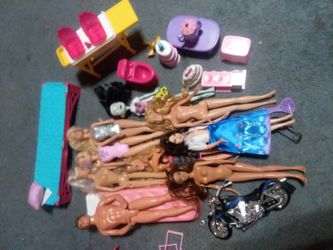 10 Barbie dolls and motorcycle and ect