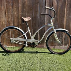 XMas Special. Electra Rosie model 26 inch women’s beach cruiser.  Pearl Silver with Bronze rims.  Three speed internal hub with coaster brake.  