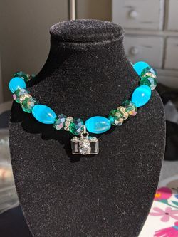 Glass bead bracelet with camera charm