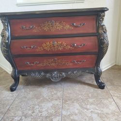 Ornate chest of drawers with lion head.