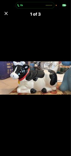 This is a vintage AMC NY NY ceramic Holstein cow cookie jar.