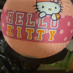 Hello Kitty sports or play ball, specifically a bouncy foam or playground ball. It features the character design with a pink background and the "Hello