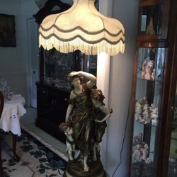 ANTIQUE LAMP. STATUE IS 32 TALL WITH LAMP SHADE IT IS 55 TALL 