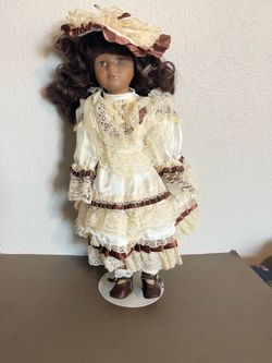 Vintage Leonardo collectors Toddler Porcelain 12” doll with a brown dress & hat